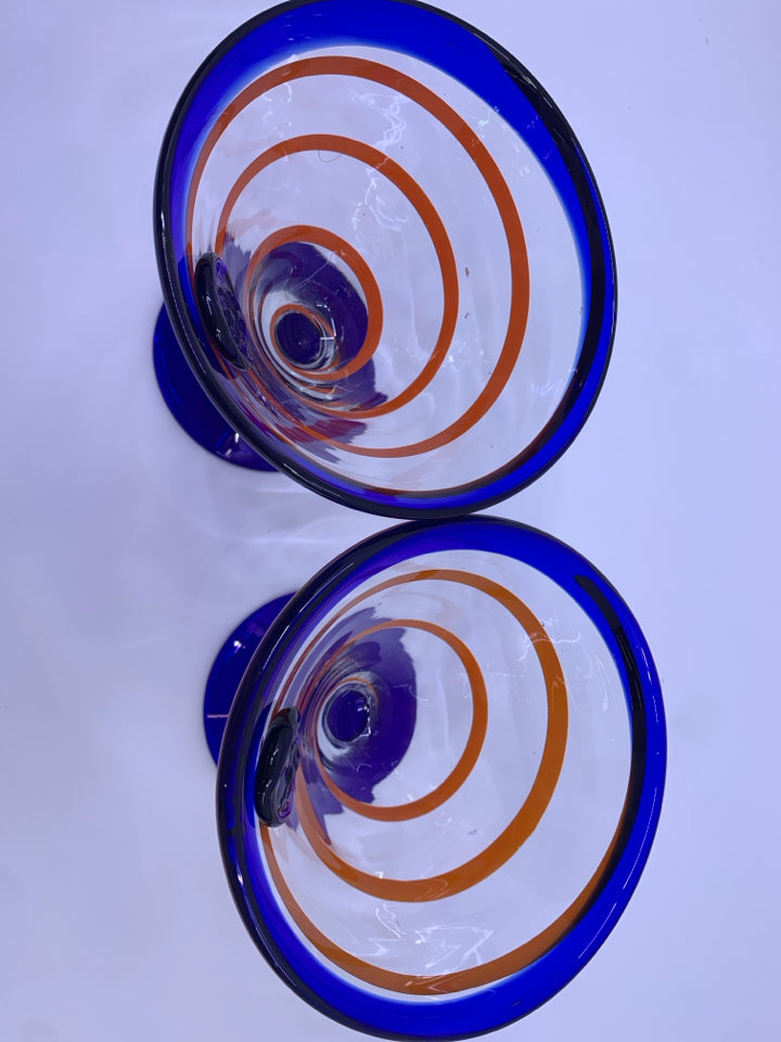 2 BLOWN GLASS FOOTED MARTINI GLASSES W/ COBALT BLUE W/ORANGE SWIRL.