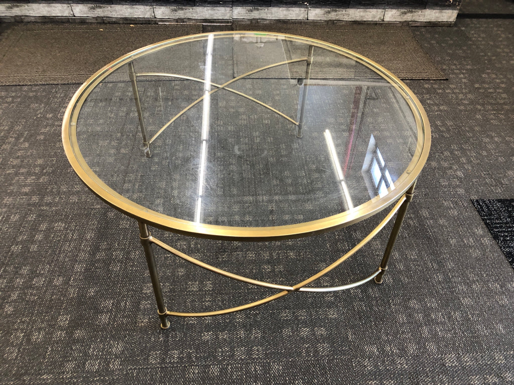 ROUND GLASS TOP COFFEE TABLE.