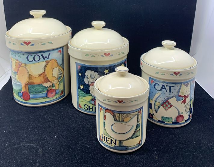 4 PRIMITIVE ANIMAL CANISTERS.