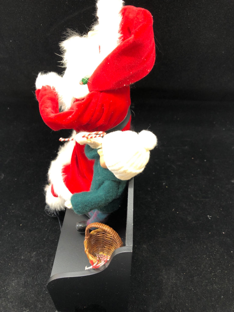 SANTA AND LITTLE BOY BYERS' CHOICE ON BENCH.