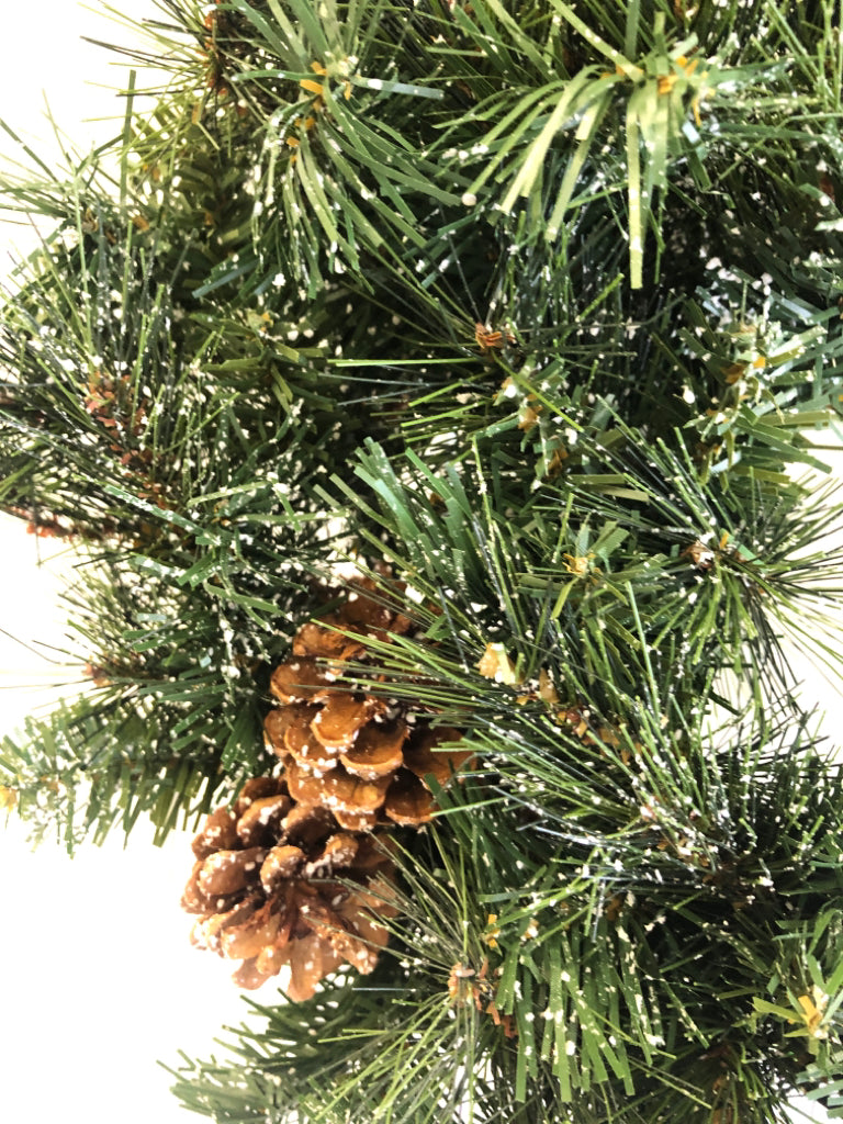 PINE WREATH W/PINECONES AND FAUX SNOW.