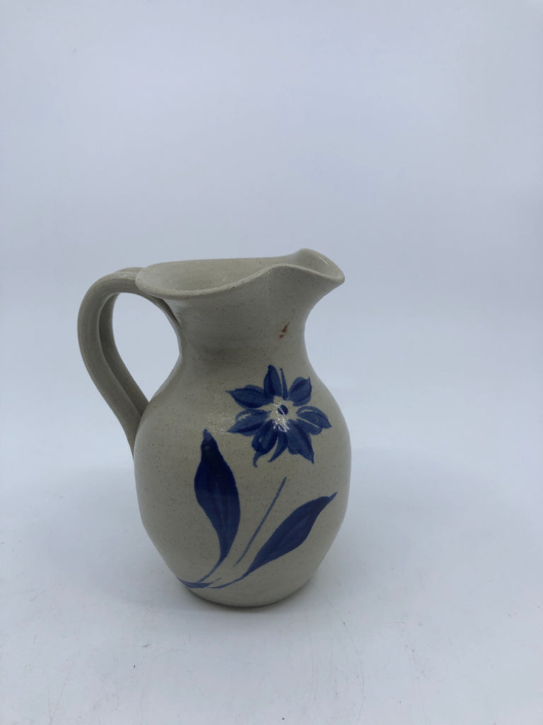 TAN SMALL PITCHER W/ PAINTED BLUE FLOWER.