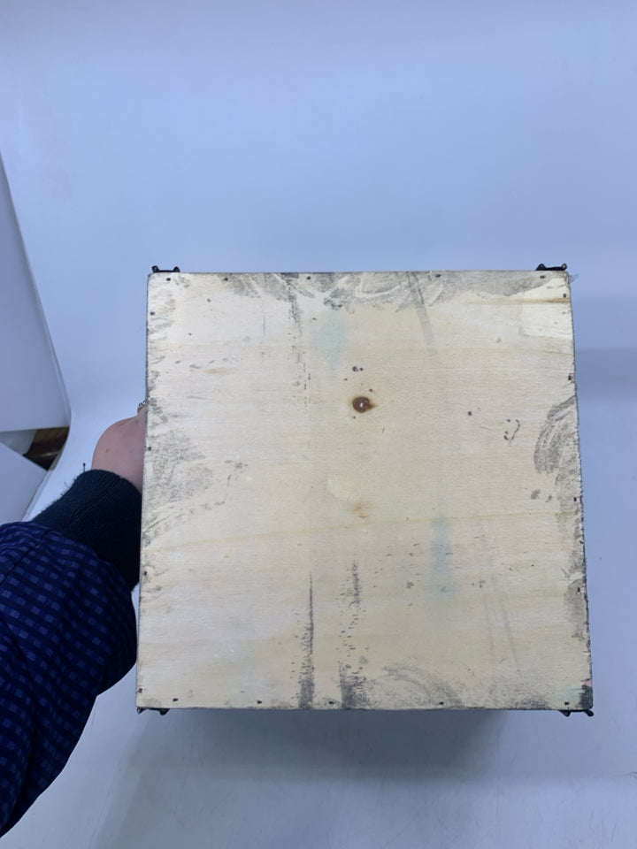 GREY PLANTER W/ GALVANIZED METAL SNOWFLAKE BLACK HANDLES.