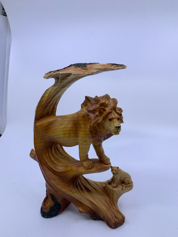 MALE LION ON ROCK COVERED BY TREE W/ LIONESS BELOW CARVED.