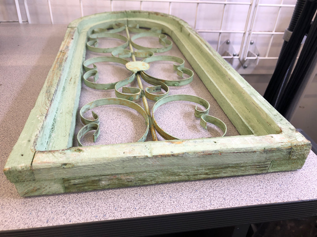 DISTRESSED GREEN PAINTED ARCH W/ METAL SCROLL WALL ART.