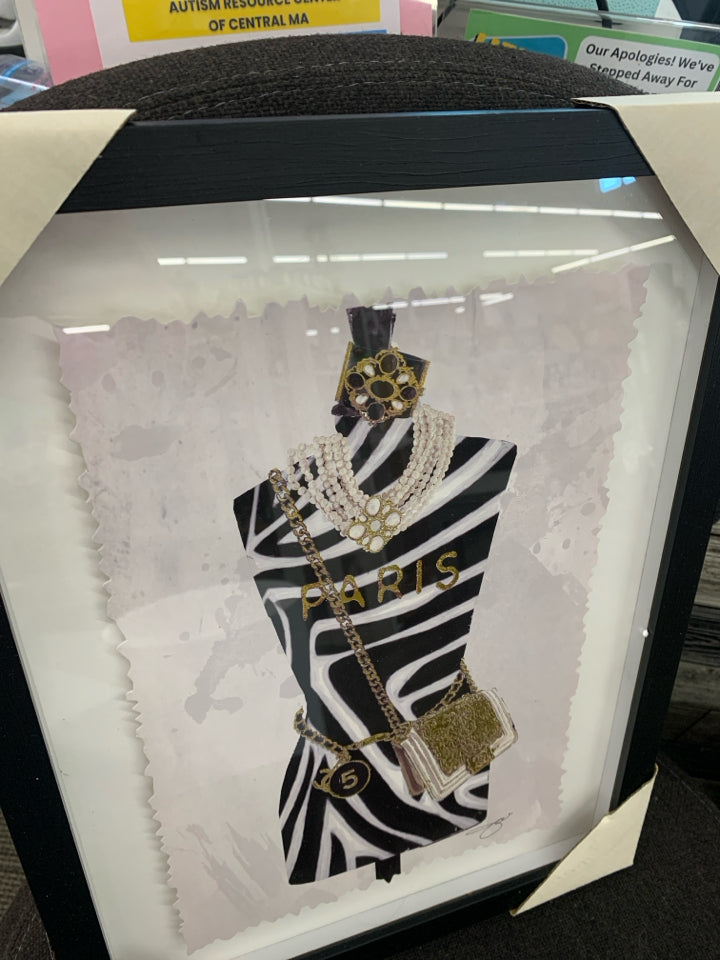 ANIMAL PRINT MANNEQUIN FORM IN BLACK FRAME.