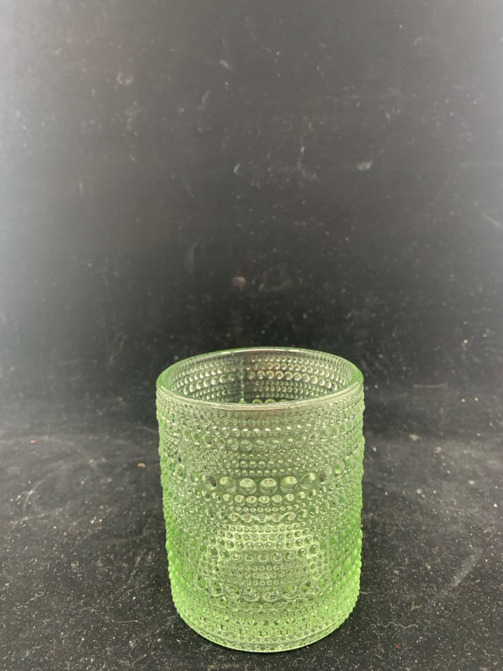 GREEN TINTED TEXTURED GLASS CANDLE HOLDER.