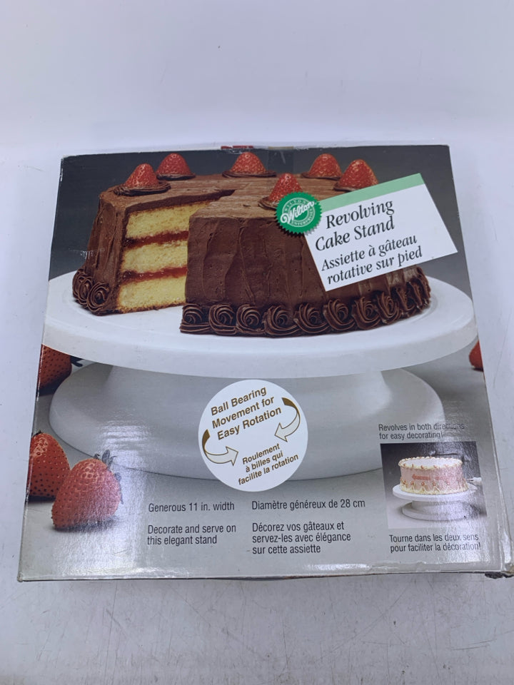 NIB WHITE PLASTIC REVOLVING CAKE STAND.