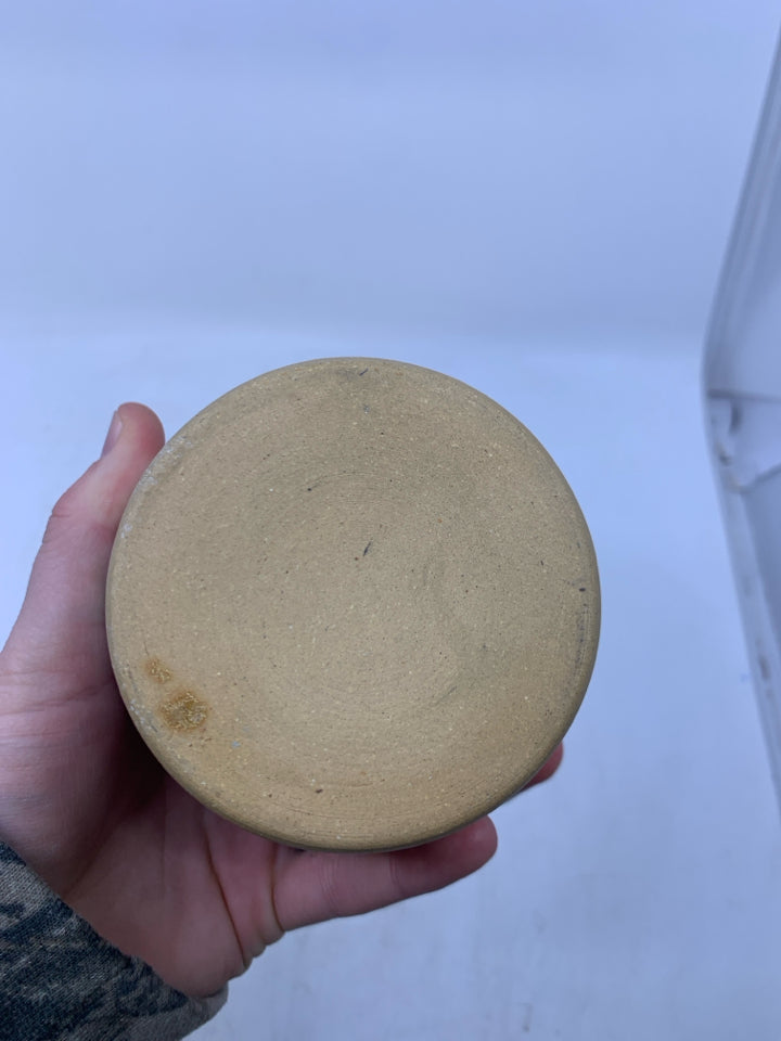 CREAM SHORT POTTERY CANISTER W/ LIGHT BLUE BAND WHITE WAVE OUTLINES.