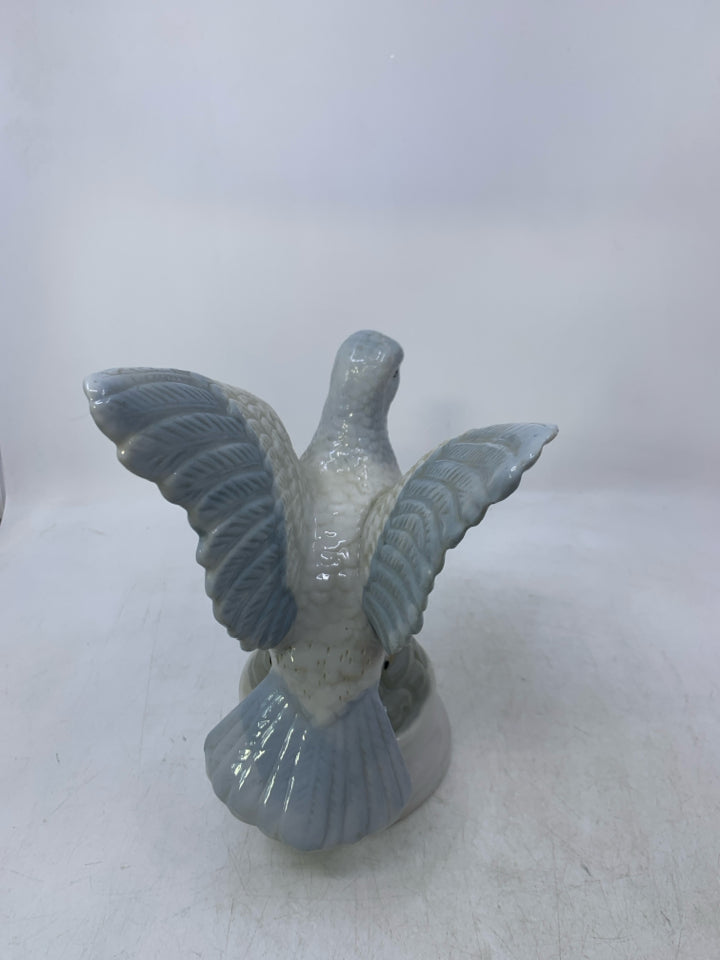 CERAMIC PIGEON ON ROCKS.