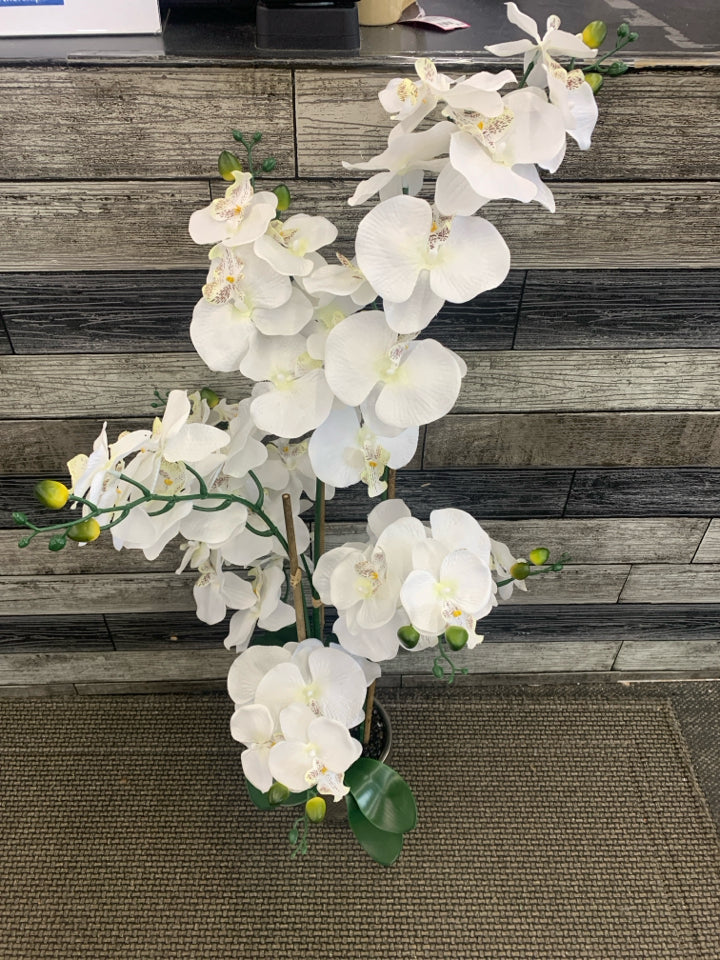 FAUX WHITE ORCHID W FAUX PEBBLES IN METAL VASE.