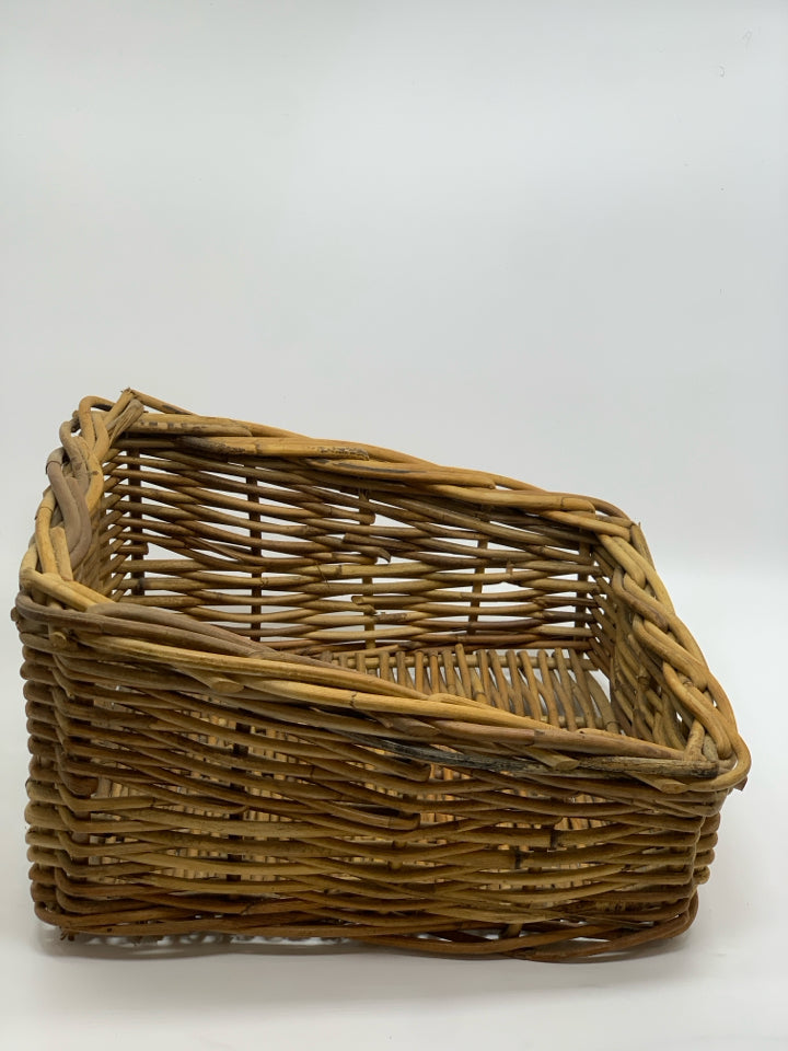 SLANTED BROWN WICKER BASKET.