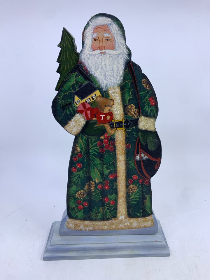 WOOD SANTA ON STAND GREEN COAT HOLDING TOYS.