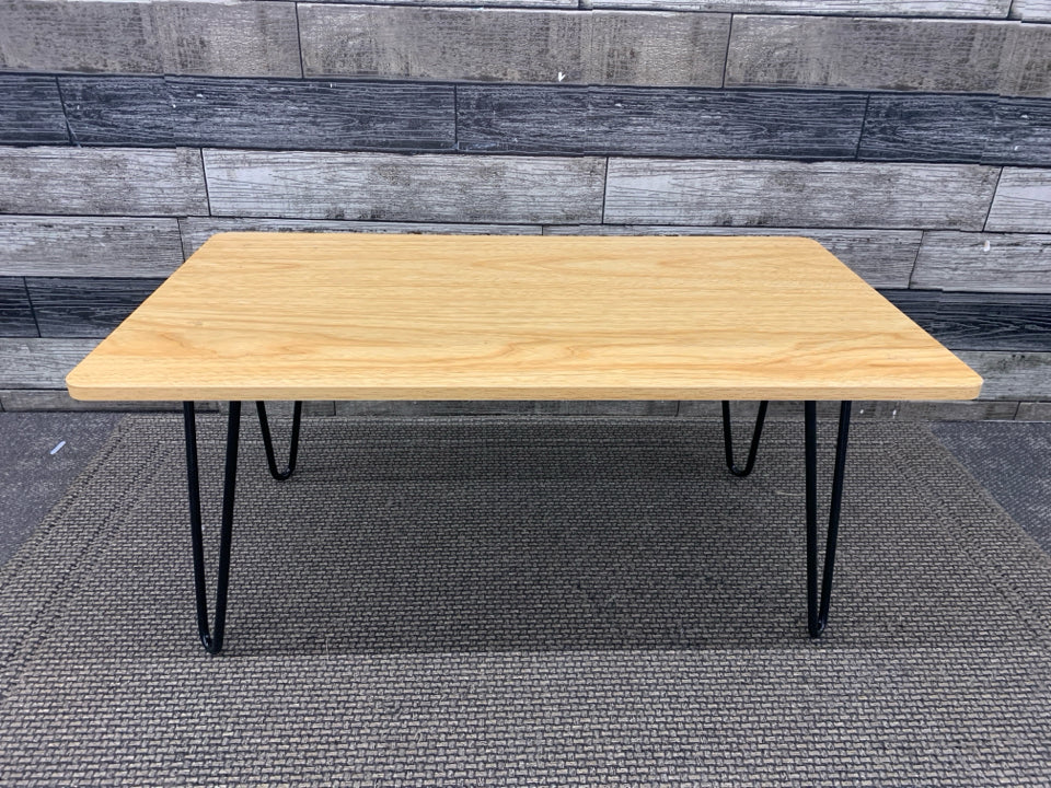 SMALL WOOD TABLE W/BLACK LEGS.