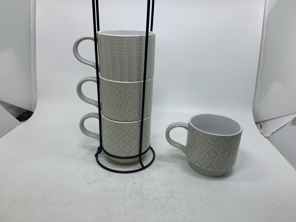 4 STACKING EMBOSSED MUGS IN STAND.