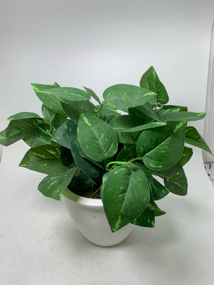 WHITE PLANTER W/ FAUX LEAVES.