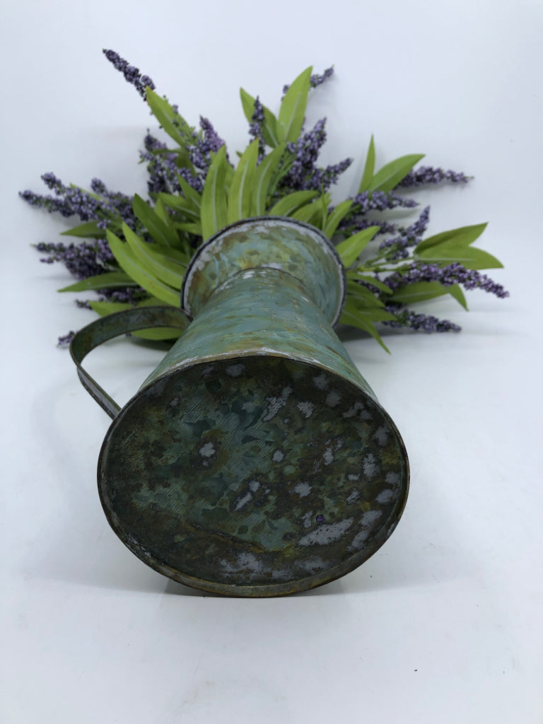 METAL PITCHER W/ FAUX PURPLE FLOWERS.