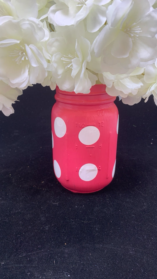 WHITE FAUX FLOWERS IN PINK POLKA DOT JAR.