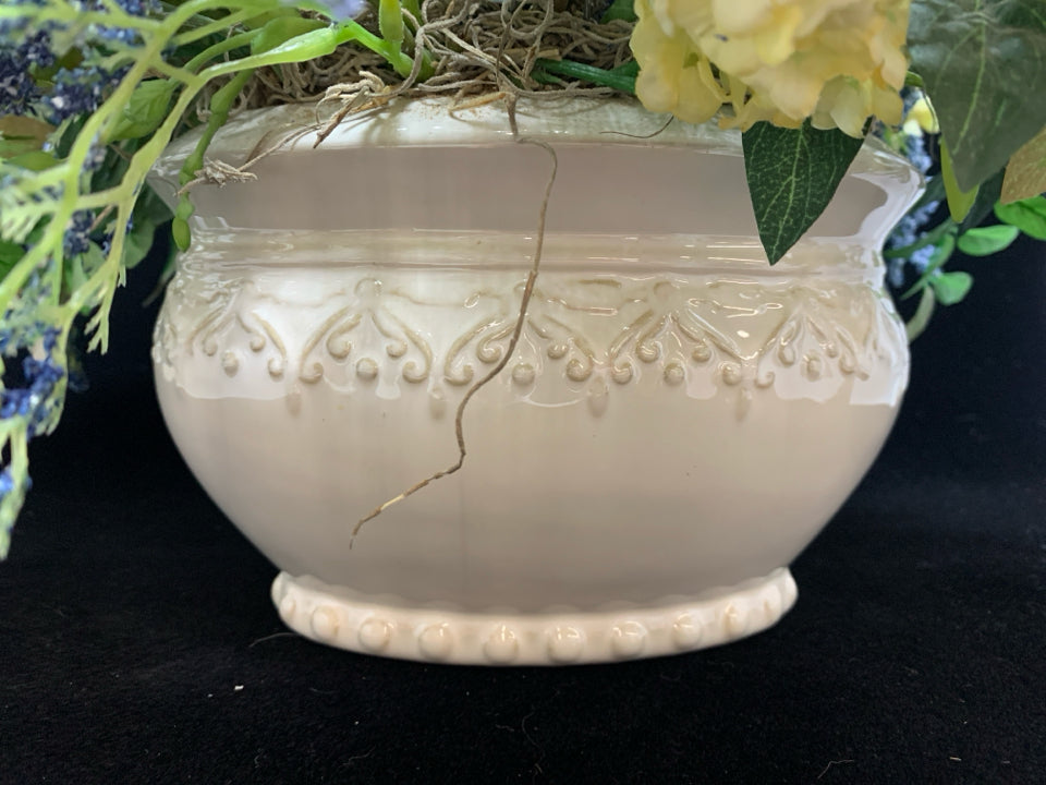 BLUE FLORALS IN WHITE PLANTER.