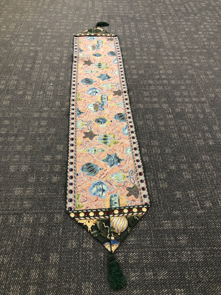 GREEN TABLE RUNNER WOVEN W/ COLORFUL ORNAMENTS.