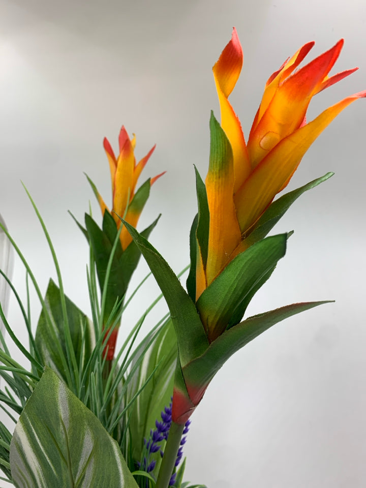 FAUX TROPICAL FLOWER IN CLEAR VASE.