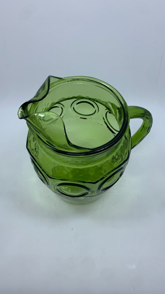 VTG GREEN GLASS PITCHER W/TEXTURED BULLSEYE PATTERN.