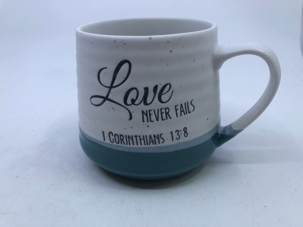 LOVE NEVER FAILS WHITE AND TEAL MUG.