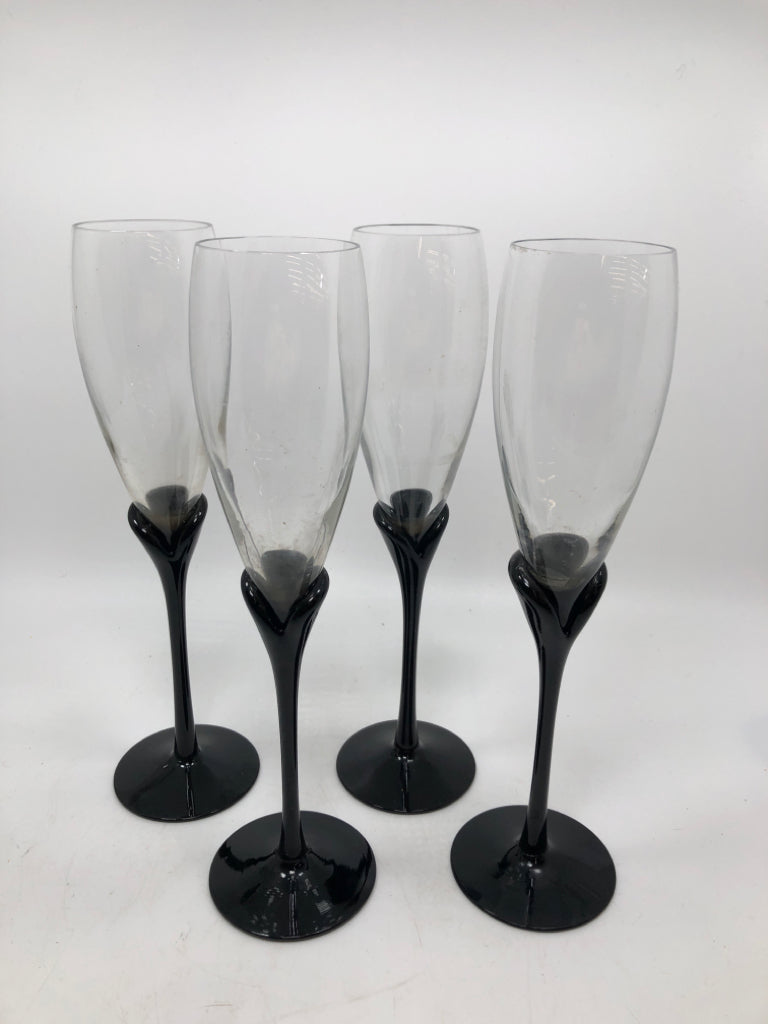 4 BLACK STEMMED CHAMPAGNE FLUTES.