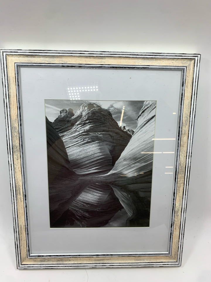 ROCK FORMATION BLACK/WHITE IN WHITE WASHED FRAME.