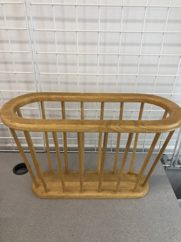 OVAL WOODEN MAGAZINE HOLDER.