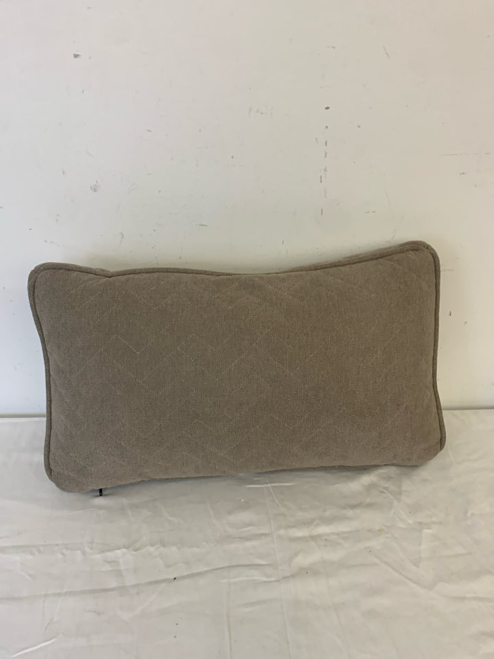 RECTANGLE DARK TAN PILLOW W/ ZIG ZAG STITCHING.