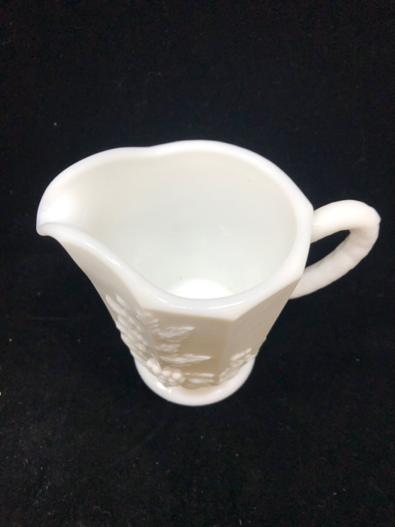 VTG MILK GLASS PITCHER W/EMBOSSED FLORAL DESIGNS.