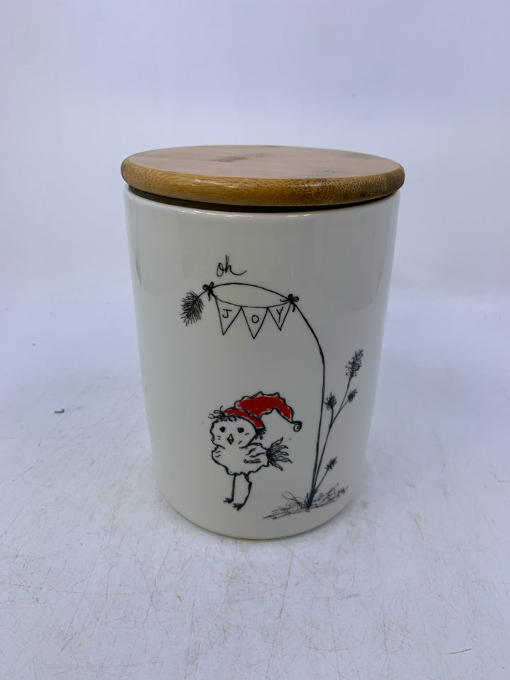 ILLUSTRATION OF BIRD W/ RED HAT OH JOY HANGING FROM TREE.