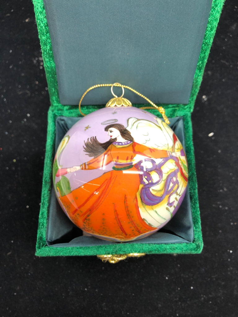 PURPLE ANGLE SPHERE ORNAMENT IN GREEN BOX.