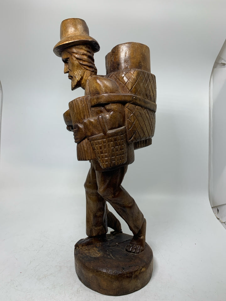 LARGE WOOD CARVED MAN W/ LARGE BACKPACK BAREFOOT WALKING.