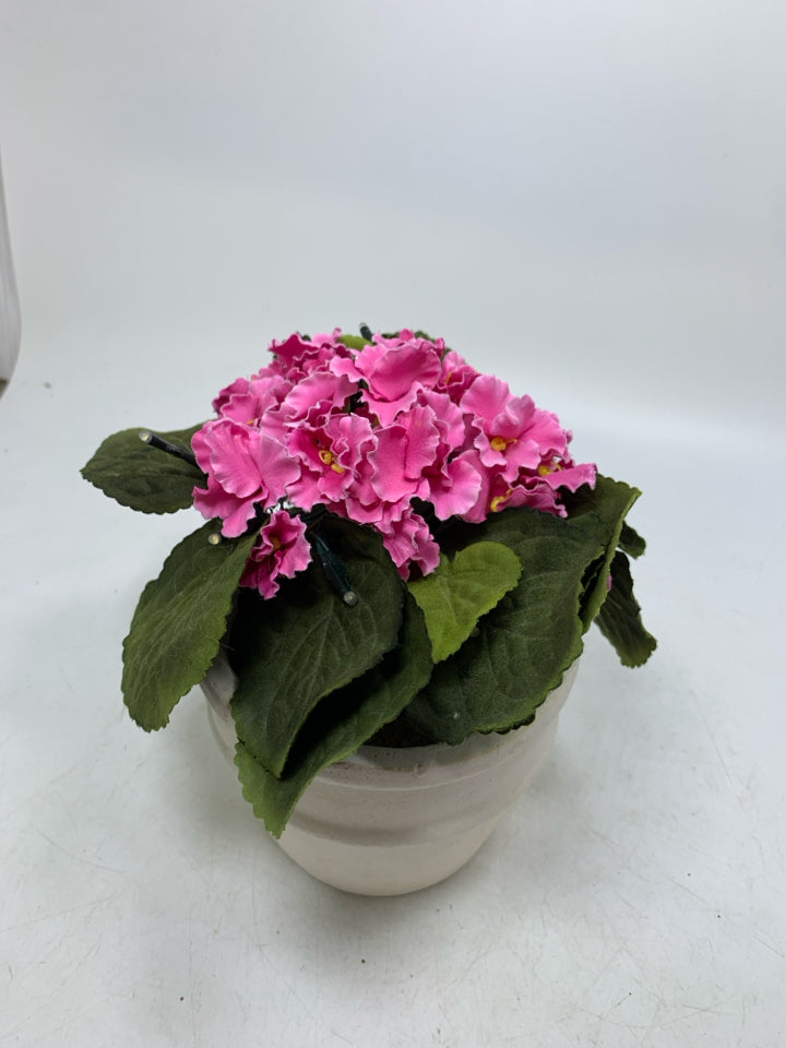 CREAM PLANTER W/ FAUX PINK FLOWERS AND LIGHTS.