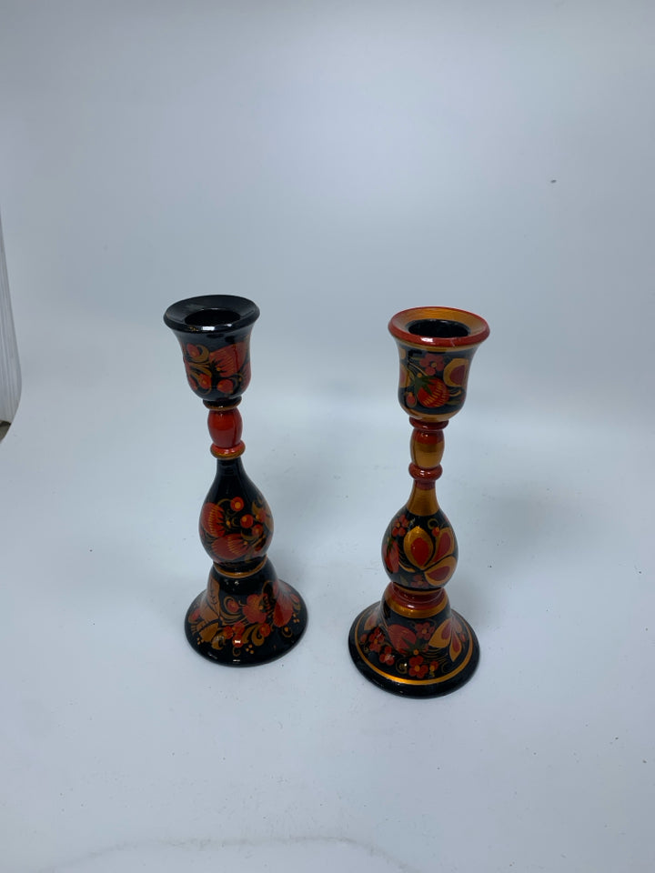 2 PAINTED RUSSIAN RED/BLACK FLORAL WOODEN TAPERED CANDLE HOLDERS.