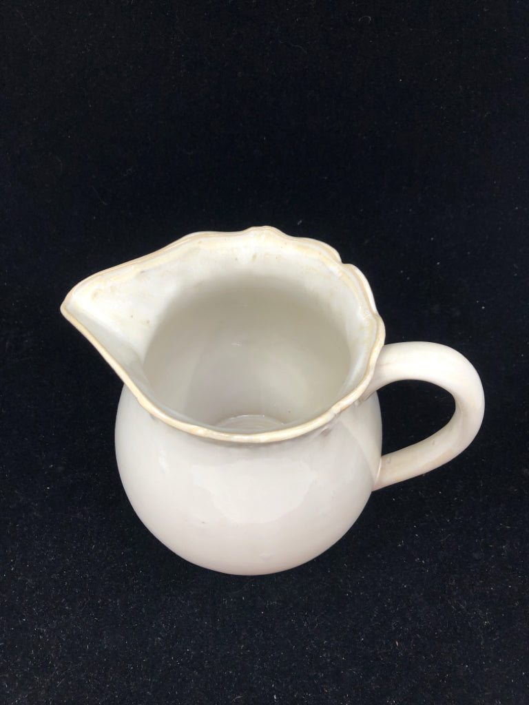 CREAM W SLIGHT EMBOSSED RIM PITCHER.
