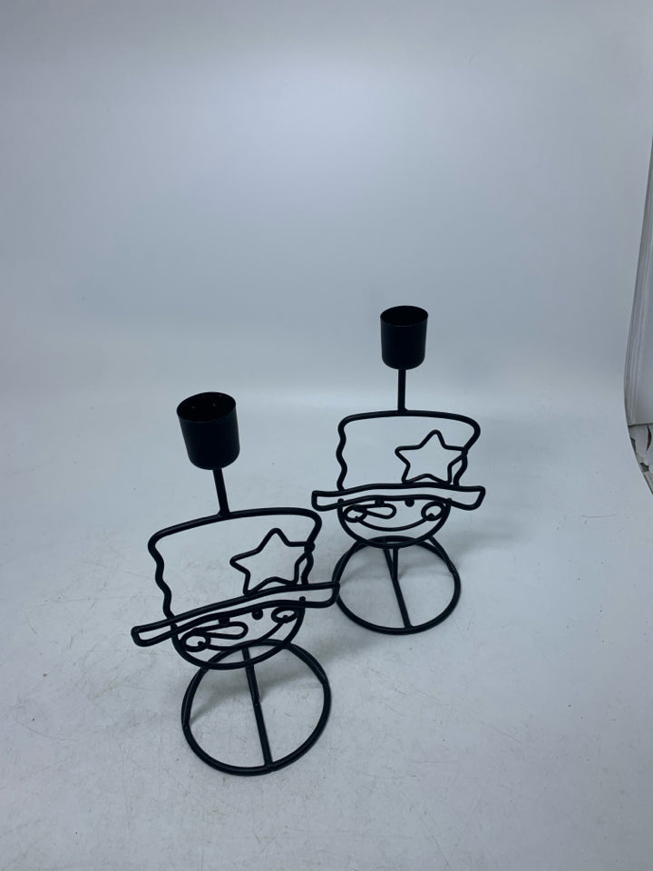 2 BLACK METAL SNOWMAN FACES W/ HATS TAPERED CANDLE HODLERS.