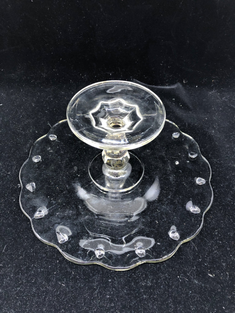 FOOTED GLASS CAKE STAND W DOT PATTERN AND WAVY EDGES.