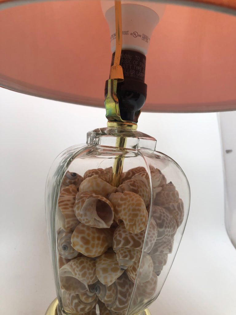 SEASHELL FILLED LAMP W/ORANGE SHADE.