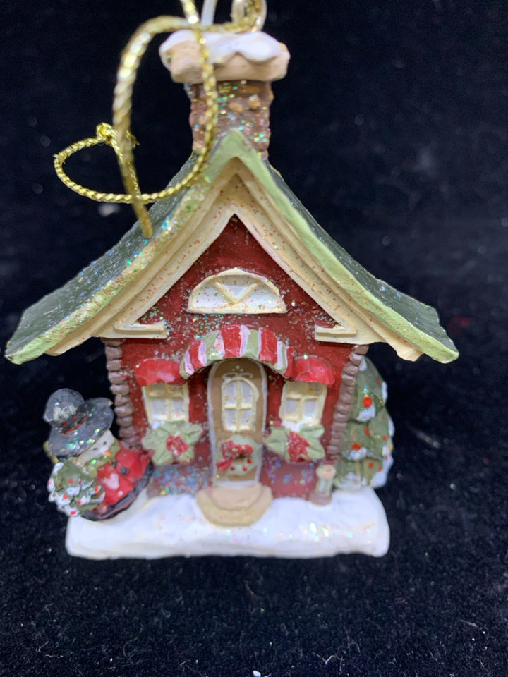 SNOWMAN IN FRONT OF HOUSE ORNAMENT.