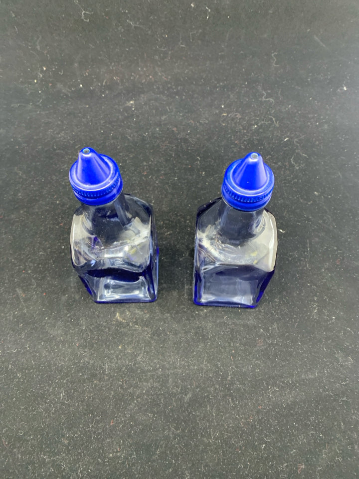 BLUE SQUARE GLASS OIL AND VINEGAR BOTTLES .