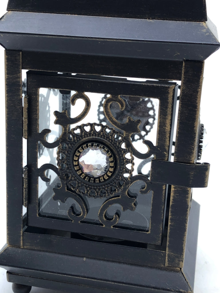 SMALL LANTERN W/ GLASS PANES JEWELS IN MIDDLE PIERCED TOP.