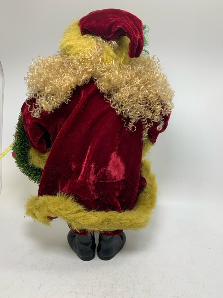 CURLY HAIRED SANTA W/ DARK RED COAT HOLDING WREATH.