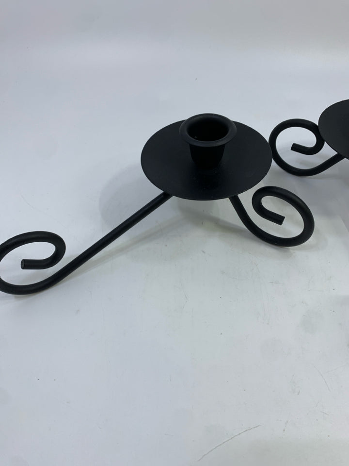 2 BLACK METAL SCROLL CANDLESTICK HOLDERS.
