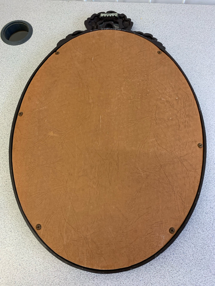 VTG OVAL MIRROR W/BROWN BORDER & FLORAL DECOR ON TOP WALL HANGING.