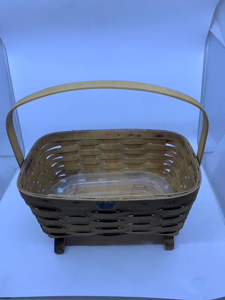 FOOTED PETERBORO BASKET W PLASTIC LINER AND HANDLE.