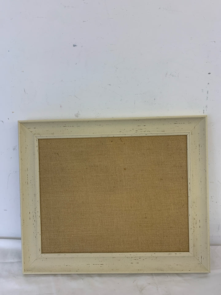 CREAM FRAMED CORK BOARD.