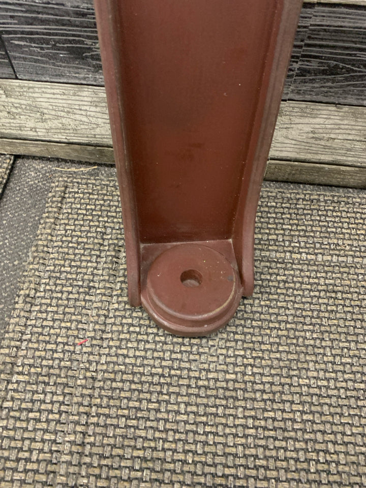 RED PRIMITIVE CANDLE HOLDER W STAR CUT OUT.
